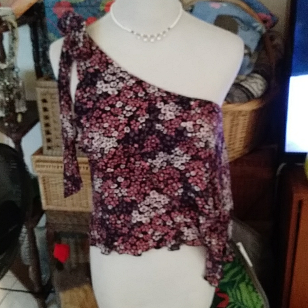 “Its pink" flowered top that is off 1 shoulder